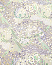 Japanese chiyogami paper featuring a light gray and turquoise stormy seascape with lightning, butterflies, and floral boats with metallic gold and silver accents.