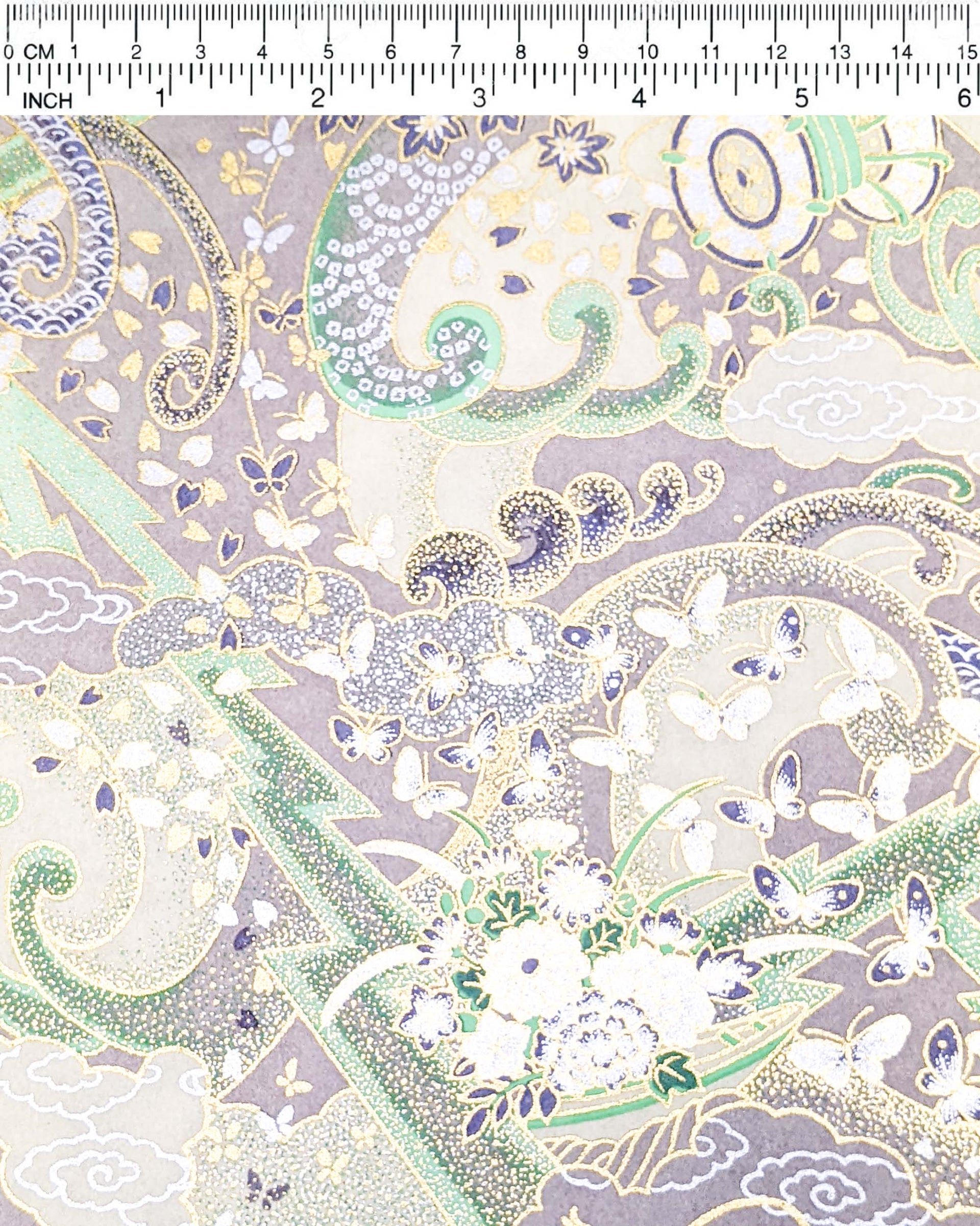 Japanese chiyogami paper featuring a light gray and turquoise stormy seascape with lightning, butterflies, and floral boats with metallic gold and silver accents.