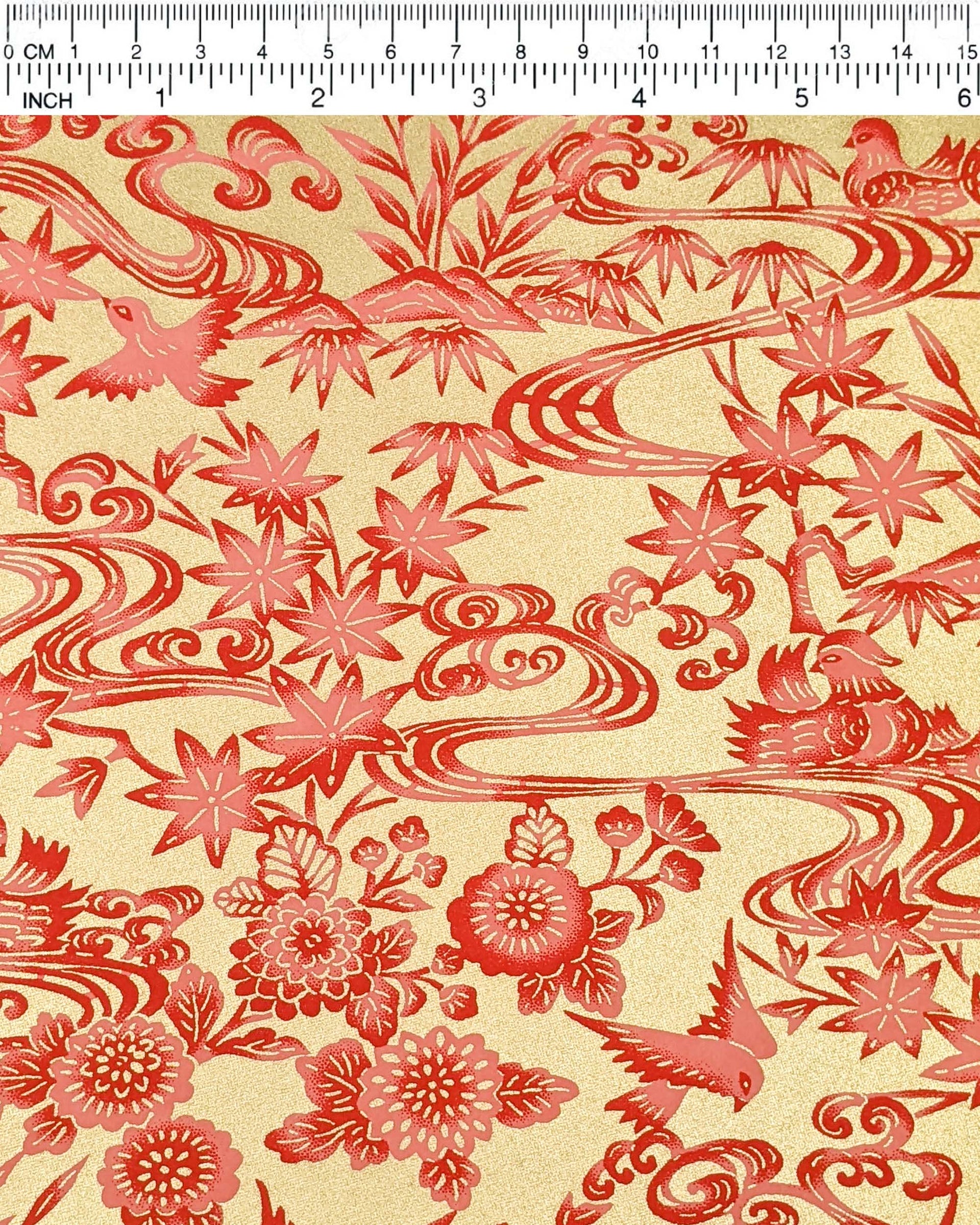 Japanese chiyogami paper featuring red birds and flowers on a metallic gold background.