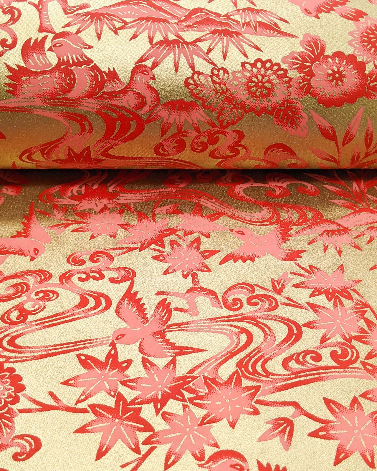 Japanese chiyogami paper featuring red birds and flowers on a metallic gold background.