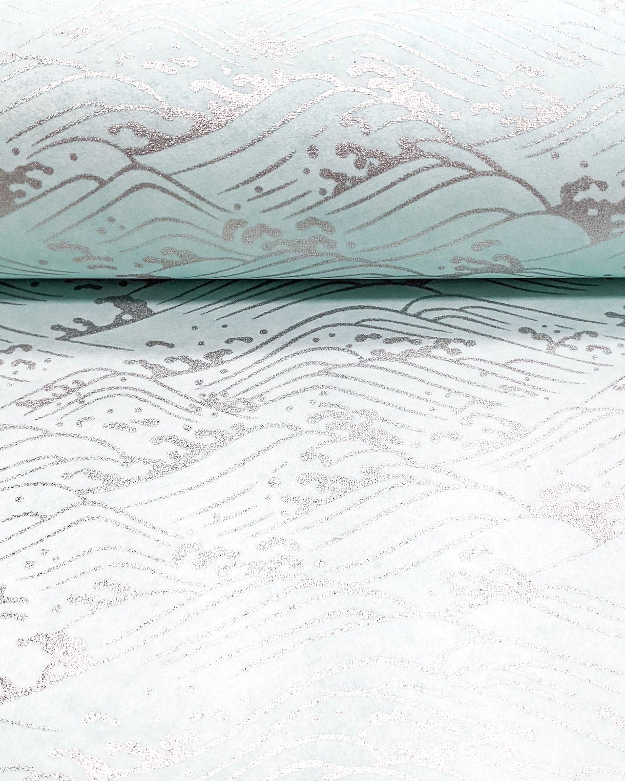 Japanese chiyogami paper featuring metallic silver waves on a light blue background.