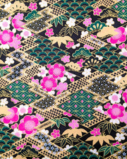Japanese chiyogami paper featuring pink & white plum blossoms on a black & green background with metallic gold accents.