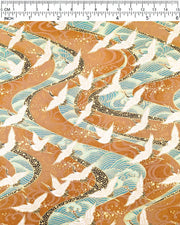 Japanese chiyogami paper featuring cranes flying over turquoise colored rivers on a brown background with metallic gold accents.