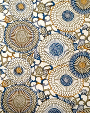 Japanese chiyogami paper featuring large blue and green zinnia flowers with orange accents on a beige background.