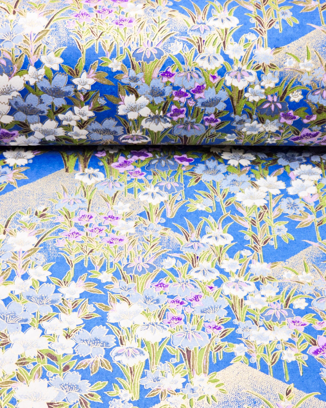 Japanese chiyogami paper featuring blue, purple, and white irises on a royal blue background with metallic gold accents.