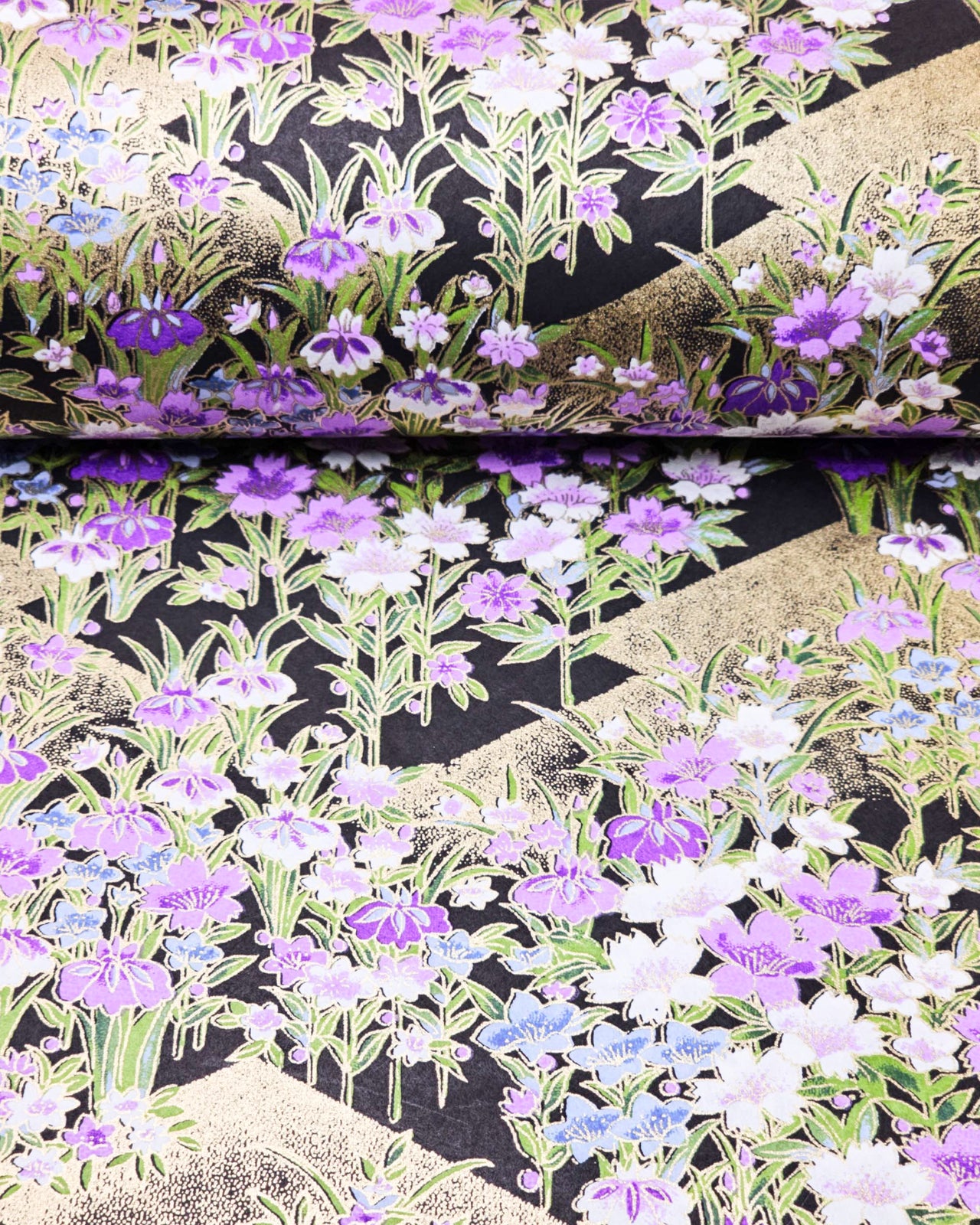 Japanese chiyogami paper featuring blue, purple, and white irises on a black background with metallic gold accents.