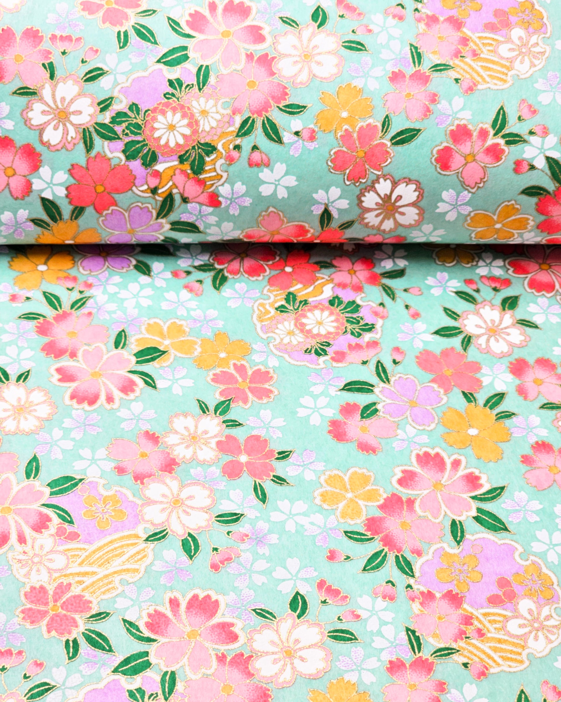Japanese chiyogami paper featuring pink, yellow, purple, and white cherry blossoms and purple yukiwas on a turquoise background with metallic gold accents.