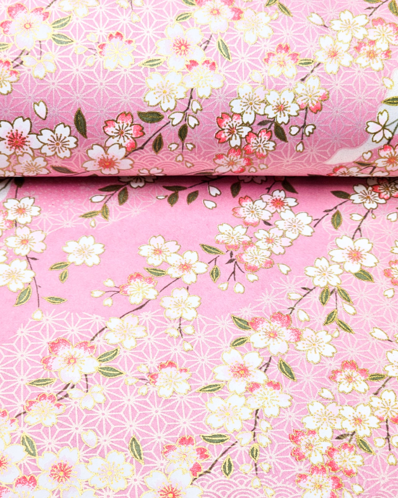Japanese chiyogami paper featuring pink & white cherry blossoms on light pink background with metallic gold accents.