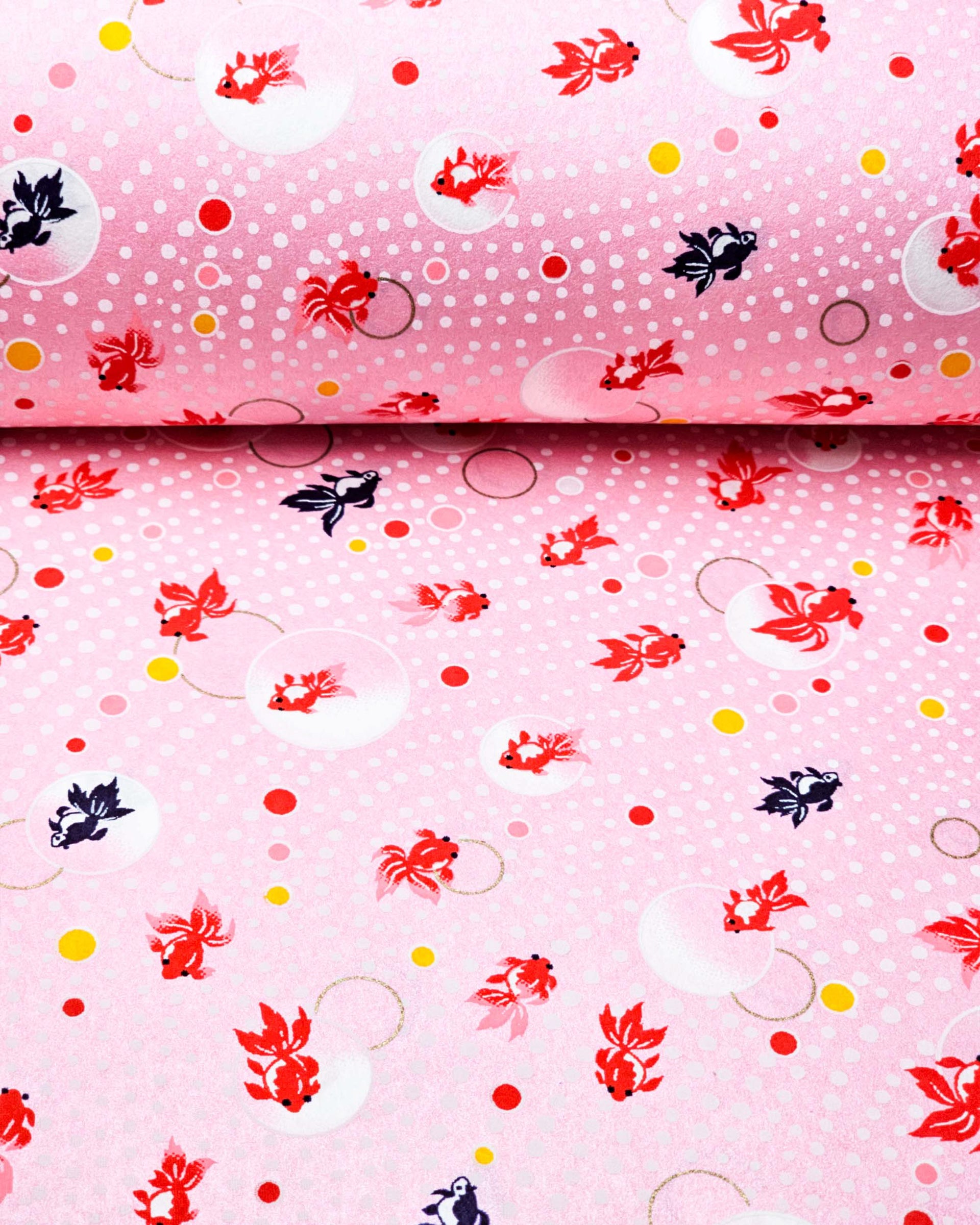 Japanese chiyogami paper featuring red and black fishes on a pearlescent pink background with metallic gold accents