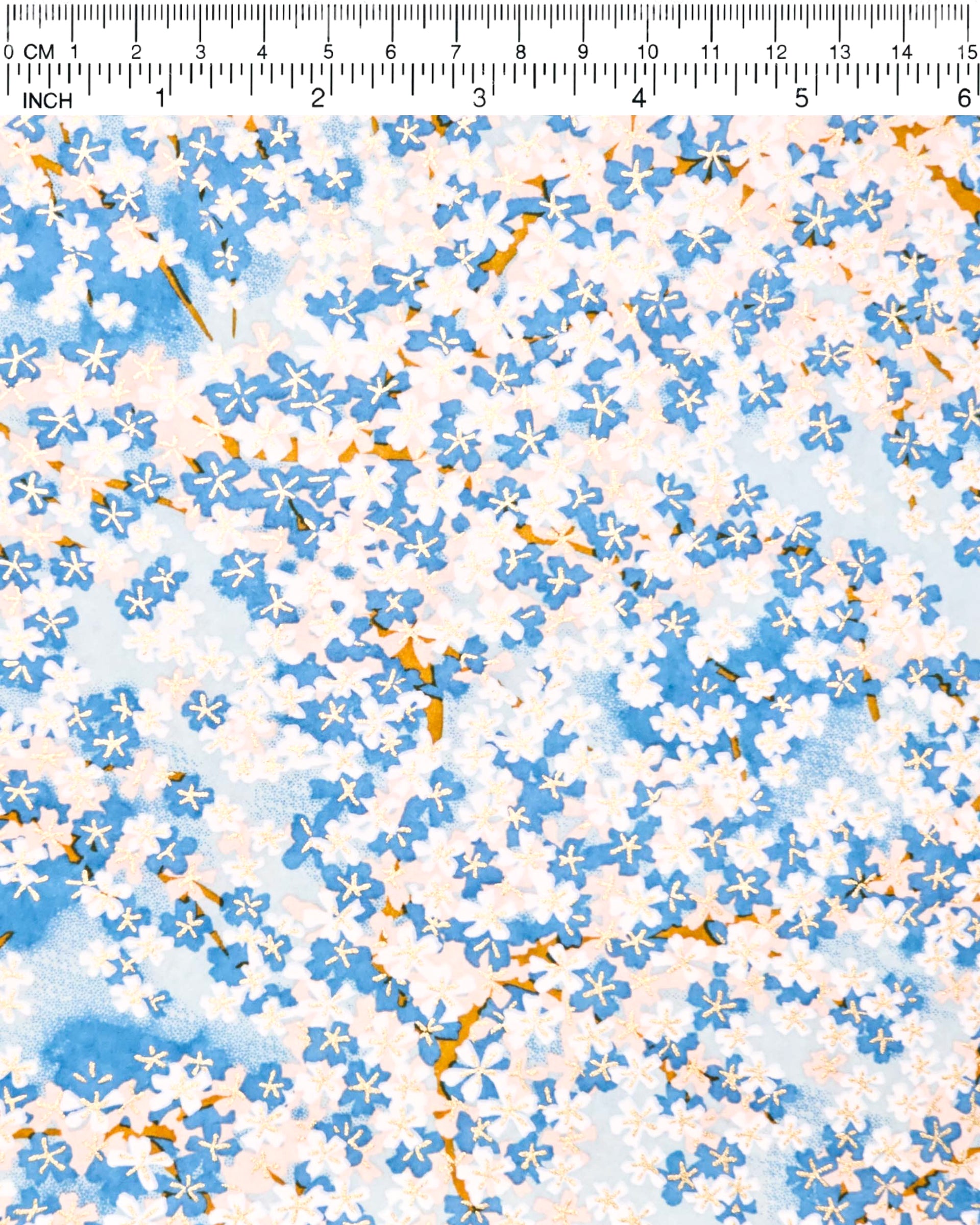 Japanese chiyogami paper featuring blue and white cherry blossoms on a blue background with metallic gold accents