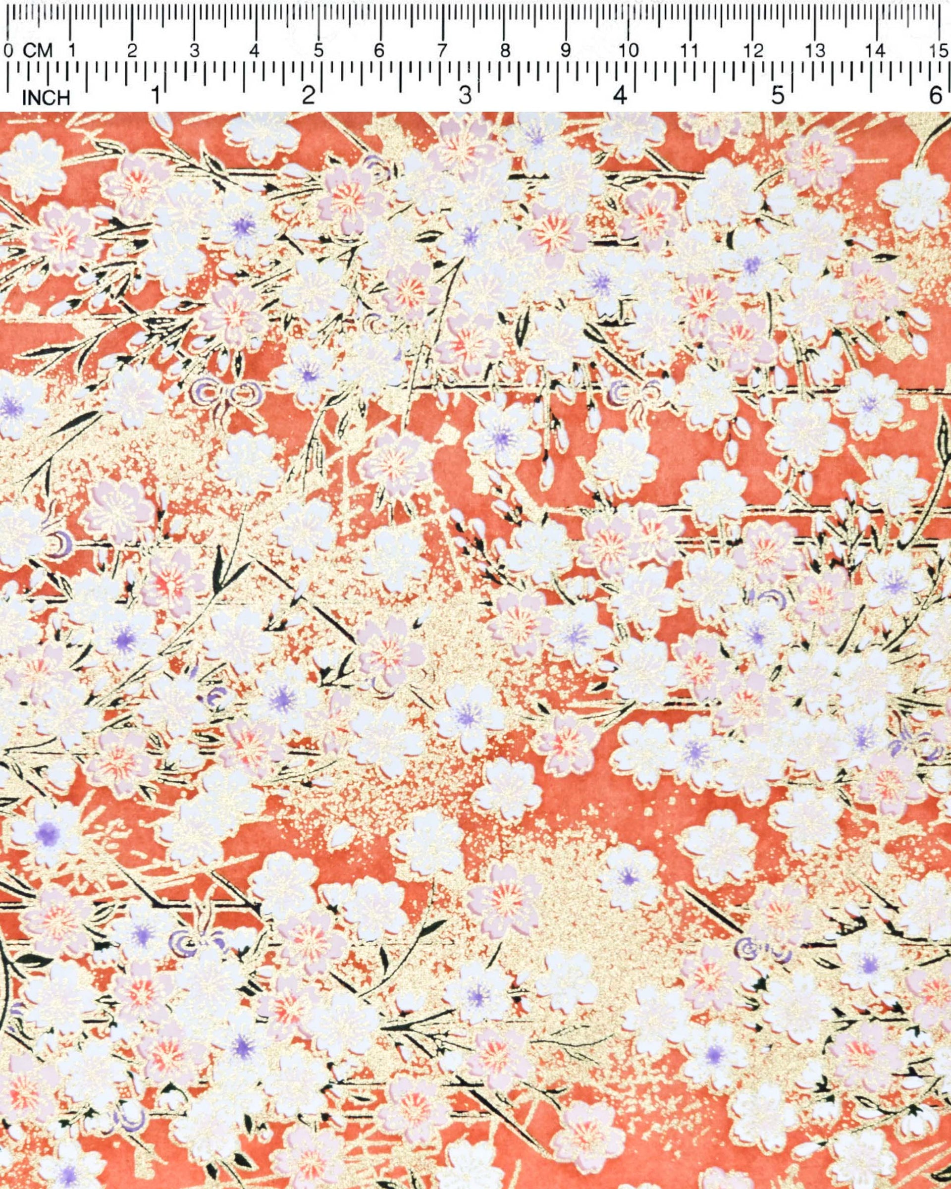 Japanese chiyogami paper featuring white and pink cherry blossoms on a reddish orange background with metallic gold accents