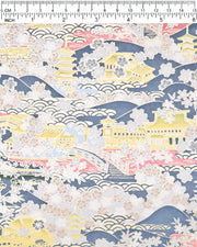 Japanese chiyogami paper featuring a village scene with yellow pagodas, buildings, and bridges with pink water, light gray cherry blossoms on a blue gray background with metallic gold accents