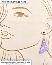 Medium wooden flared drop shaped earrings featuring purple cherry blossoms on a cream background metallic gold details.