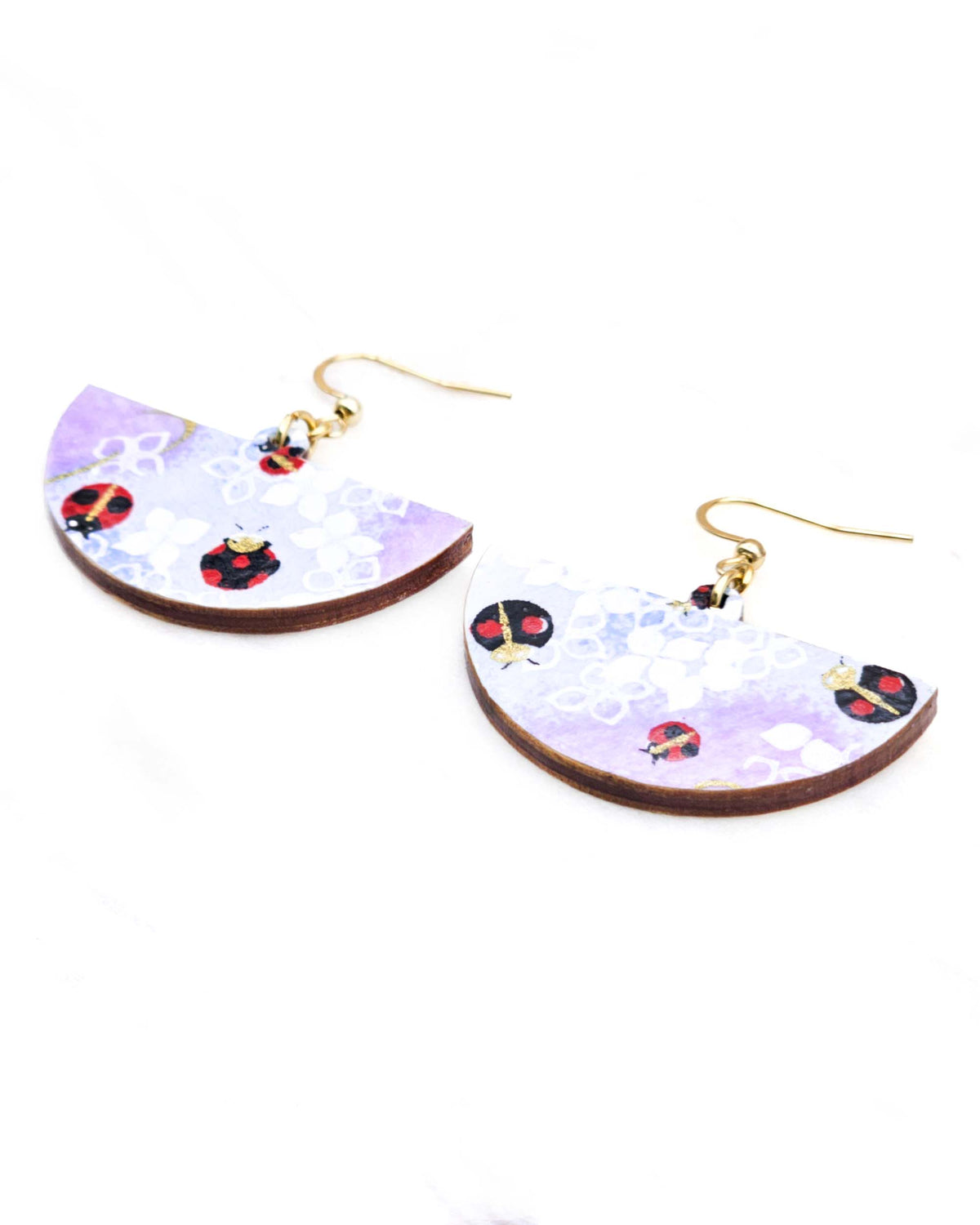 Medium wooden half circle shaped earrings featuring ladybugs on a purple and blue background with metallic gold details.