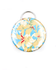 Magnetic bottle opener featuring beige leaves on a light blue background with metallic gold accents.