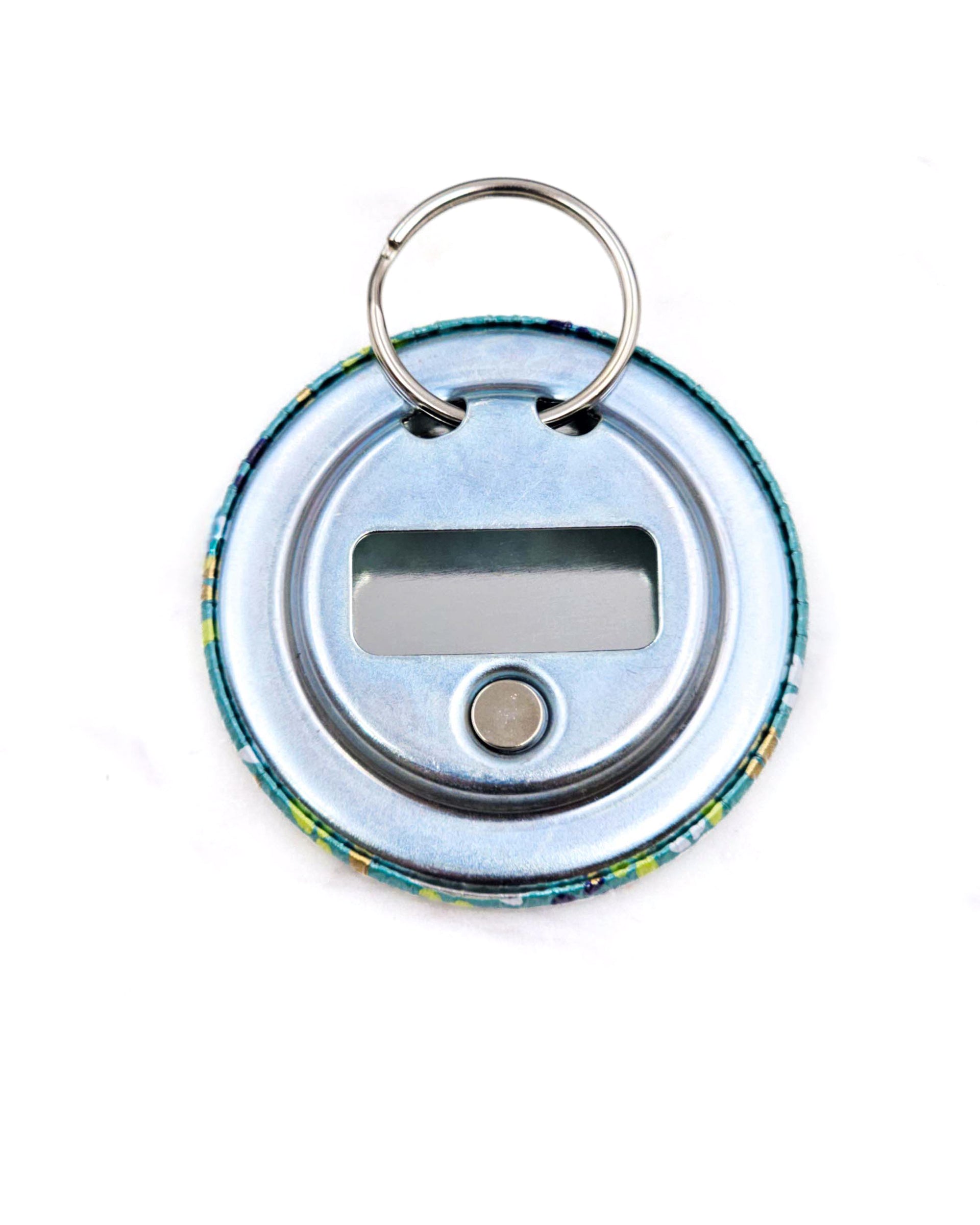 Magnetic bottle opener featuring small butterflies on a green background with metallic gold accents.