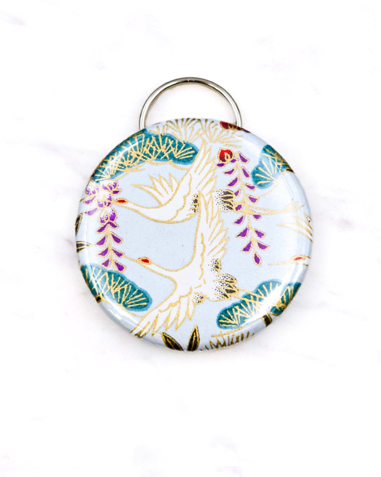 Magnetic bottle opener featuring white cranes and purple wisteria on a light blue background with metallic gold accents.