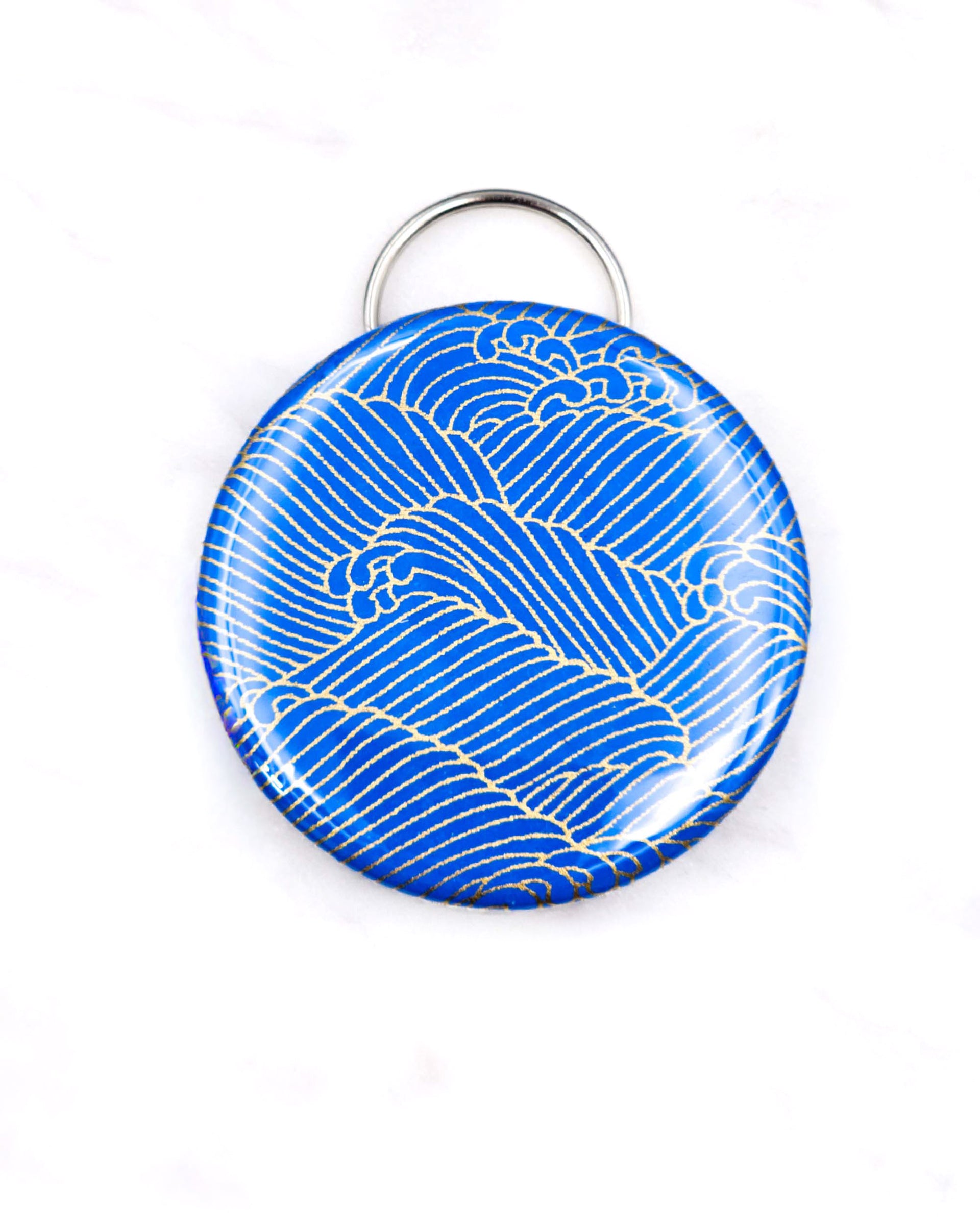 Magnetic bottle opener featuring metallic gold waves on a royal blue background.