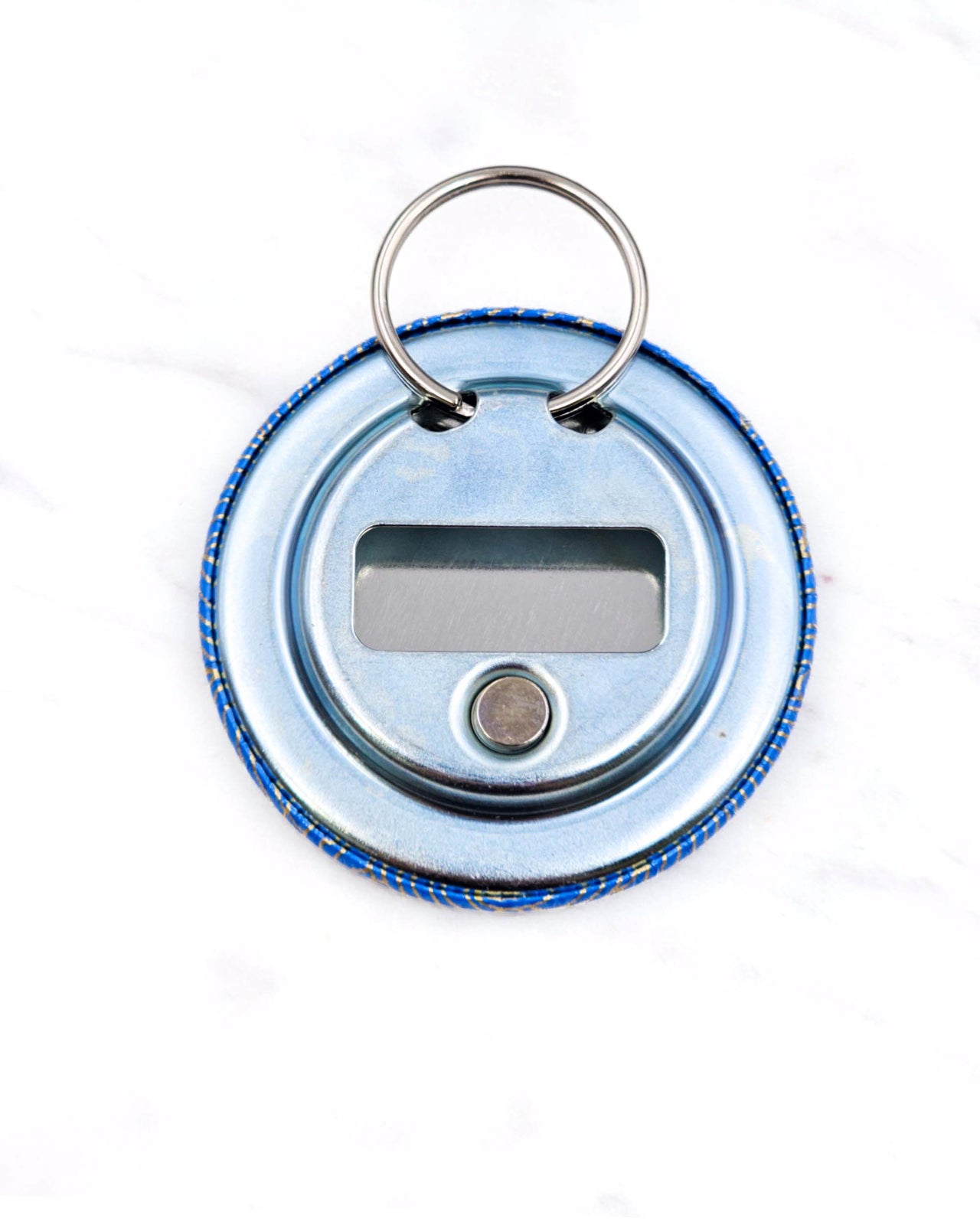 Magnetic bottle opener featuring metallic gold waves on a royal blue background.