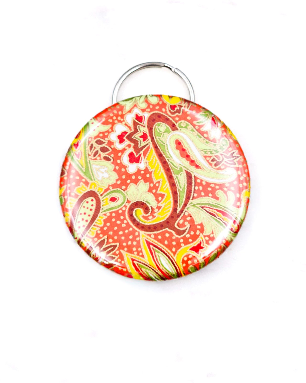 Magnetic bottle opener featuring a green and yellow paisley design on an orange background with metallic gold accents.