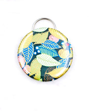 Magnetic bottle opener featuring yellow, blue, and green leaves and persimmons on a green background with metallic gold accents.