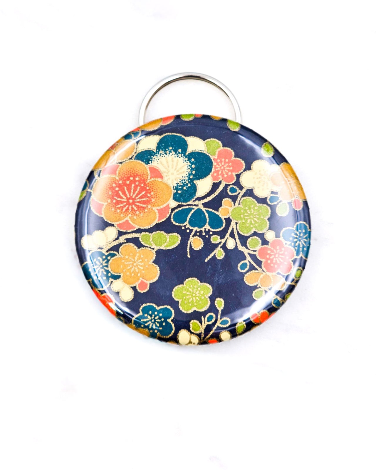 Magnetic bottle opener featuring orange and blue plum blossoms on a dark blue background with metallic gold accents.