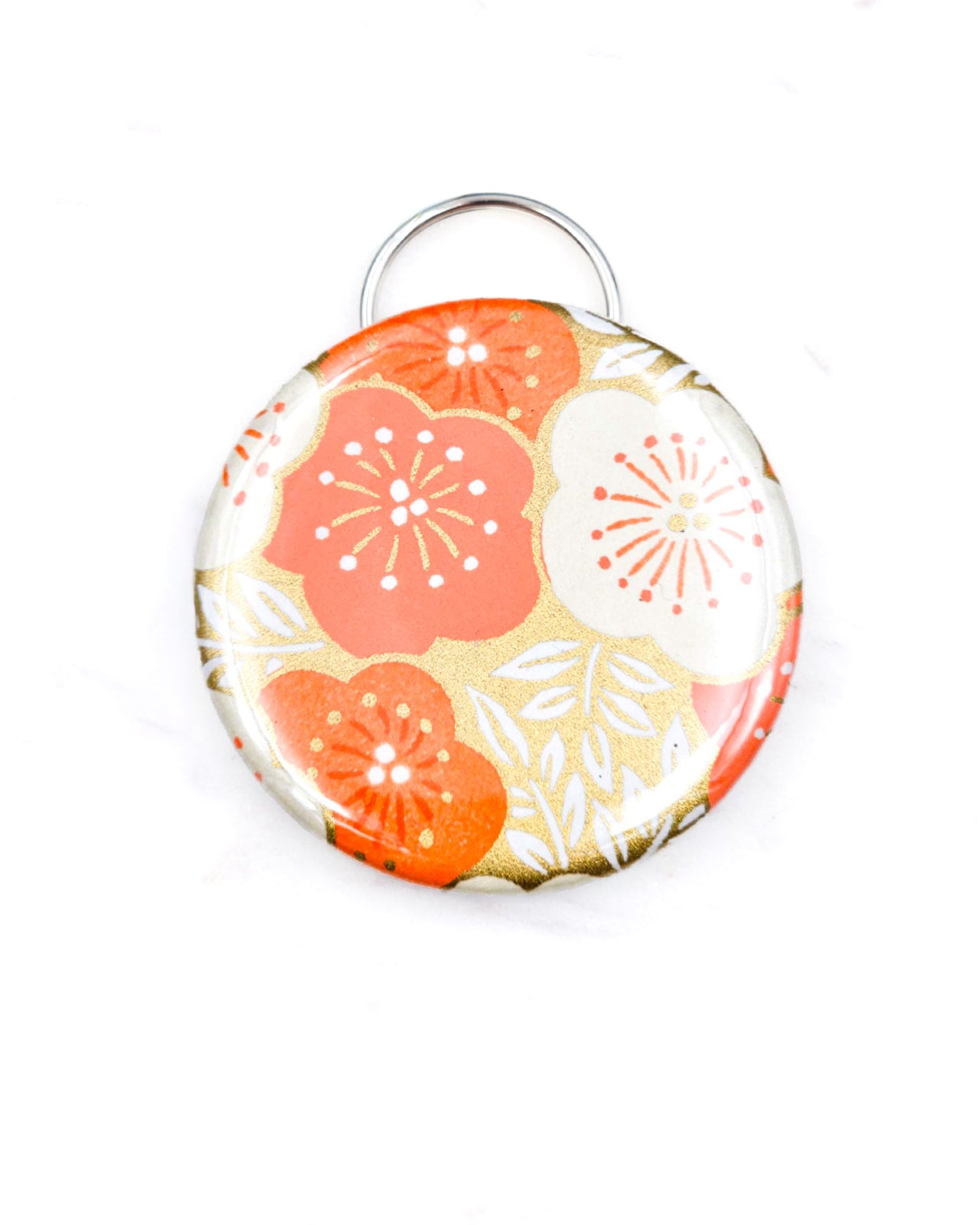 Magnetic bottle opener featuring orange and cream plum blossoms on an a metallic gold background.