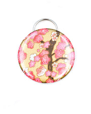 Magnetic bottle opener featuring a pink plum blossom tree on a metallic gold background.