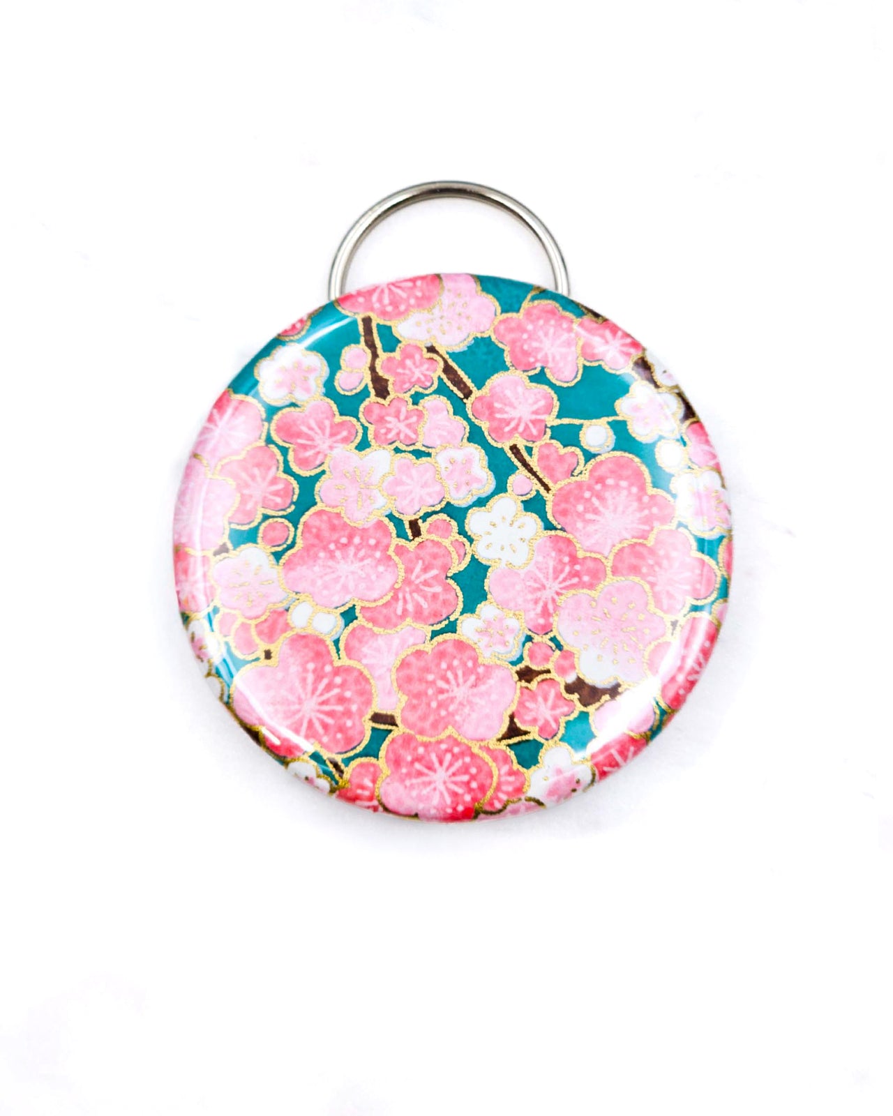 Magnetic bottle opener featuring pink plum blossoms on a teal green background with metallic gold accents.