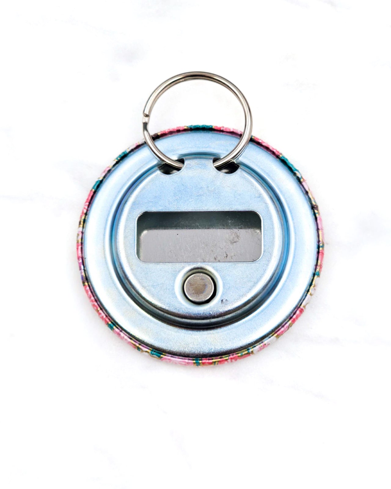 Magnetic bottle opener featuring pink plum blossoms on a teal green background with metallic gold accents.