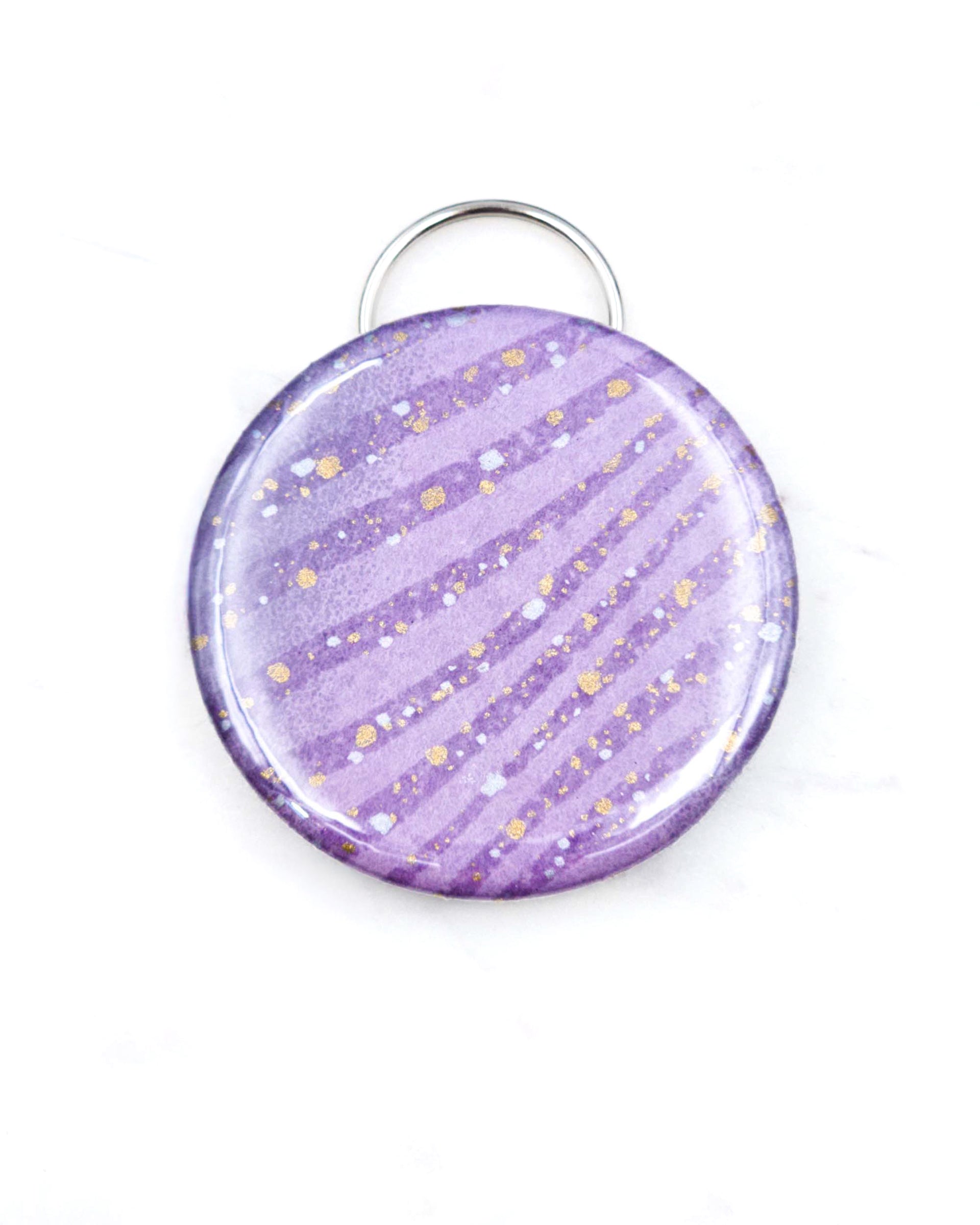 Magnetic bottle opener featuring purple swirls with metallic gold accents.