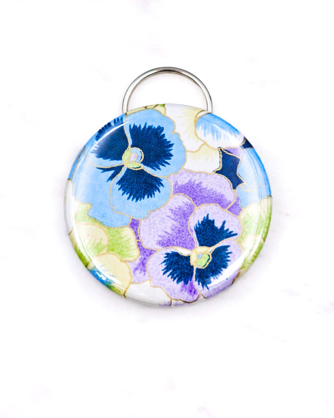 Magnetic bottle opener featuring purple and blue pansies background with metallic gold accents.