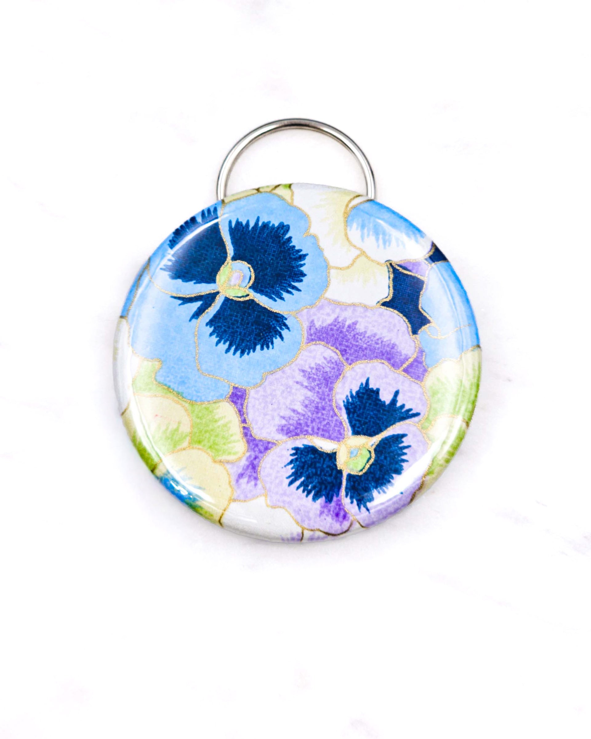 Magnetic bottle opener featuring purple, blue, and green pansies with metallic gold accents.
