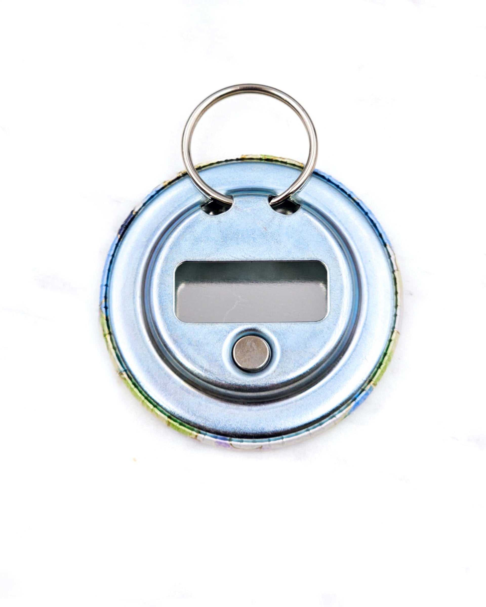 Magnetic bottle opener featuring purple, blue, and green pansies with metallic gold accents.