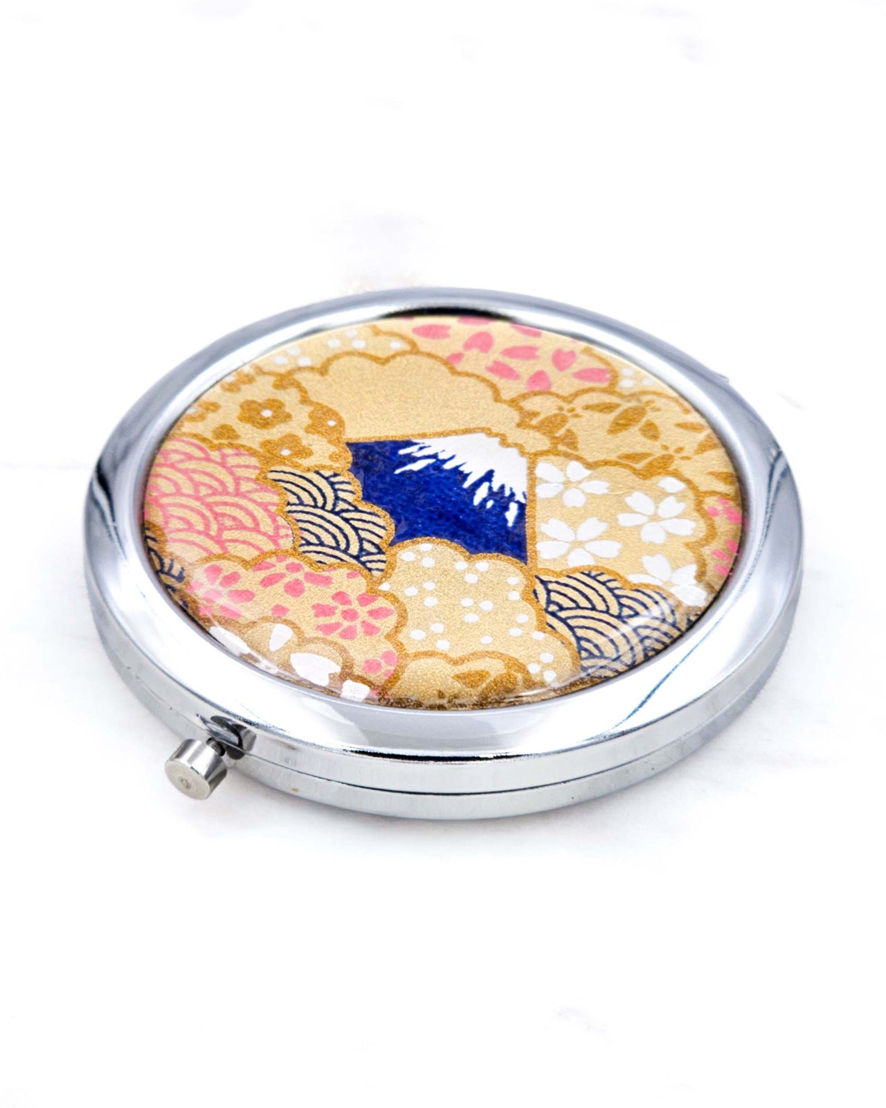 Silver metal compact mirror featuring a blue Mount Fuji on a metallic gold background.