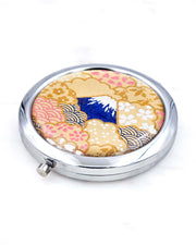Silver metal compact mirror featuring a blue Mount Fuji on a metallic gold background.