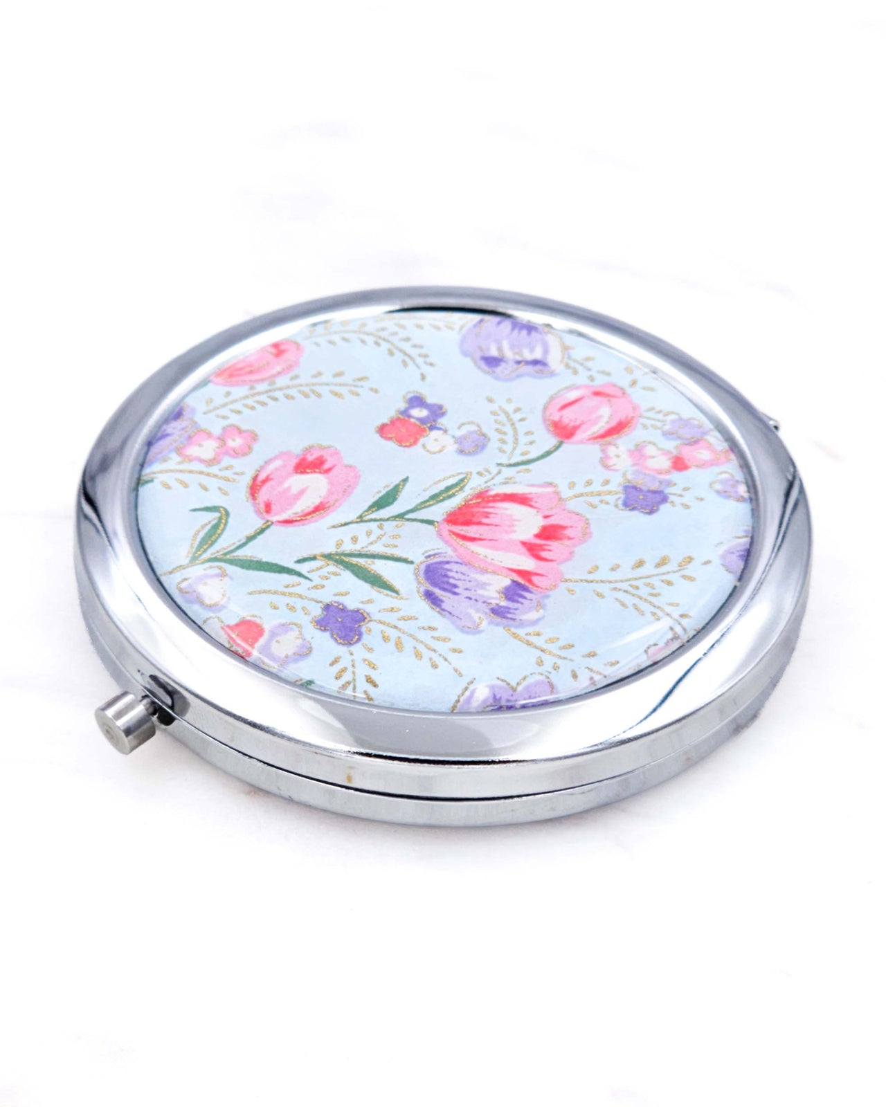 Silver metal compact mirror featuring purple and pink tulips on a light blue background with metallic gold accents.