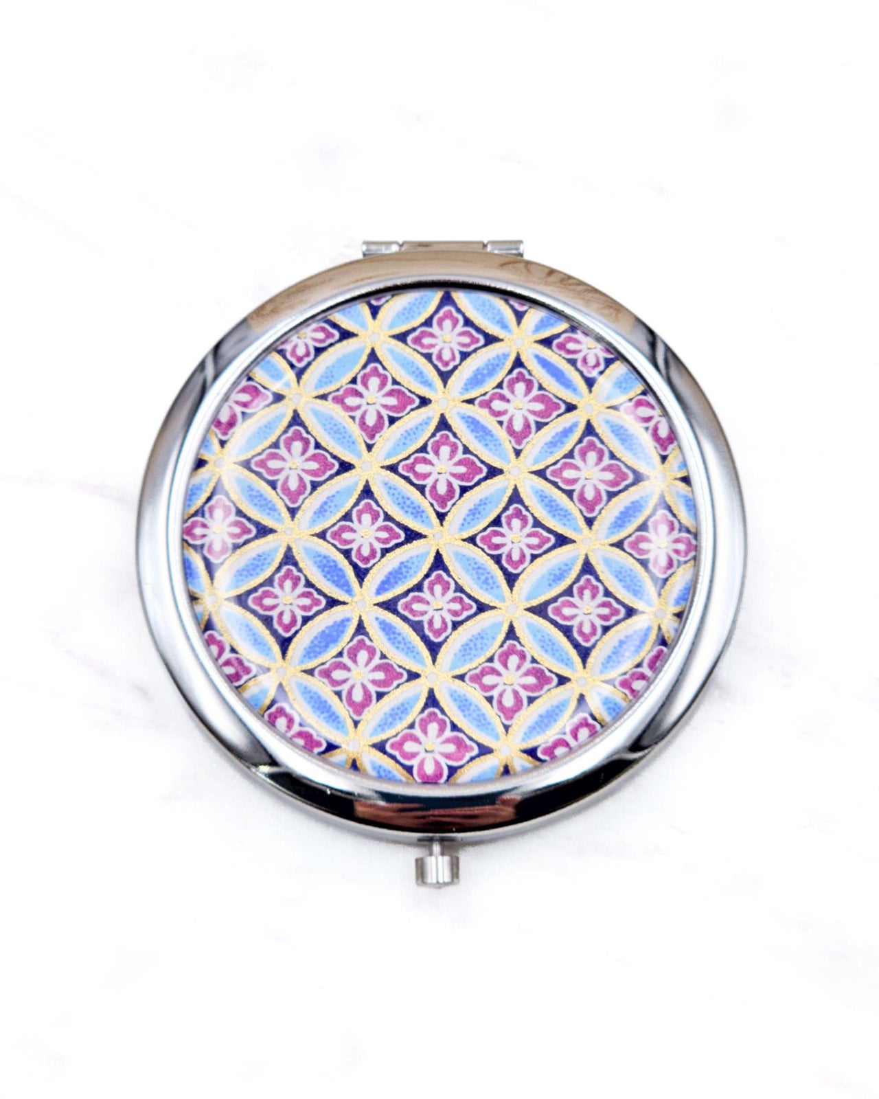 Round silver metal compact mirror featuring a traditional blue shippo pattern with purple hanabishi in the center with metallic gold accents.