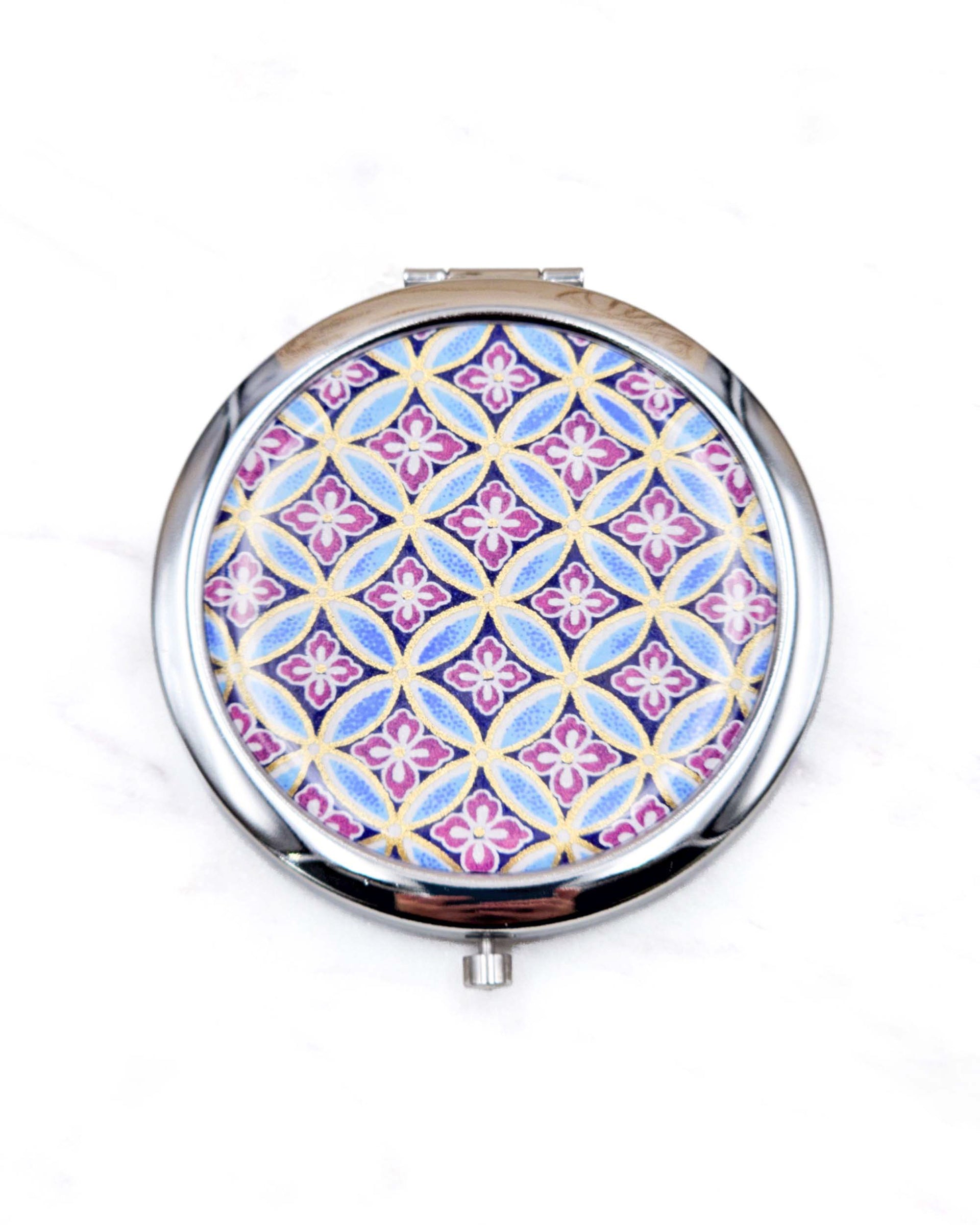 Round silver metal compact mirror featuring a traditional blue shippo pattern with purple hanabishi in the center with metallic gold accents.