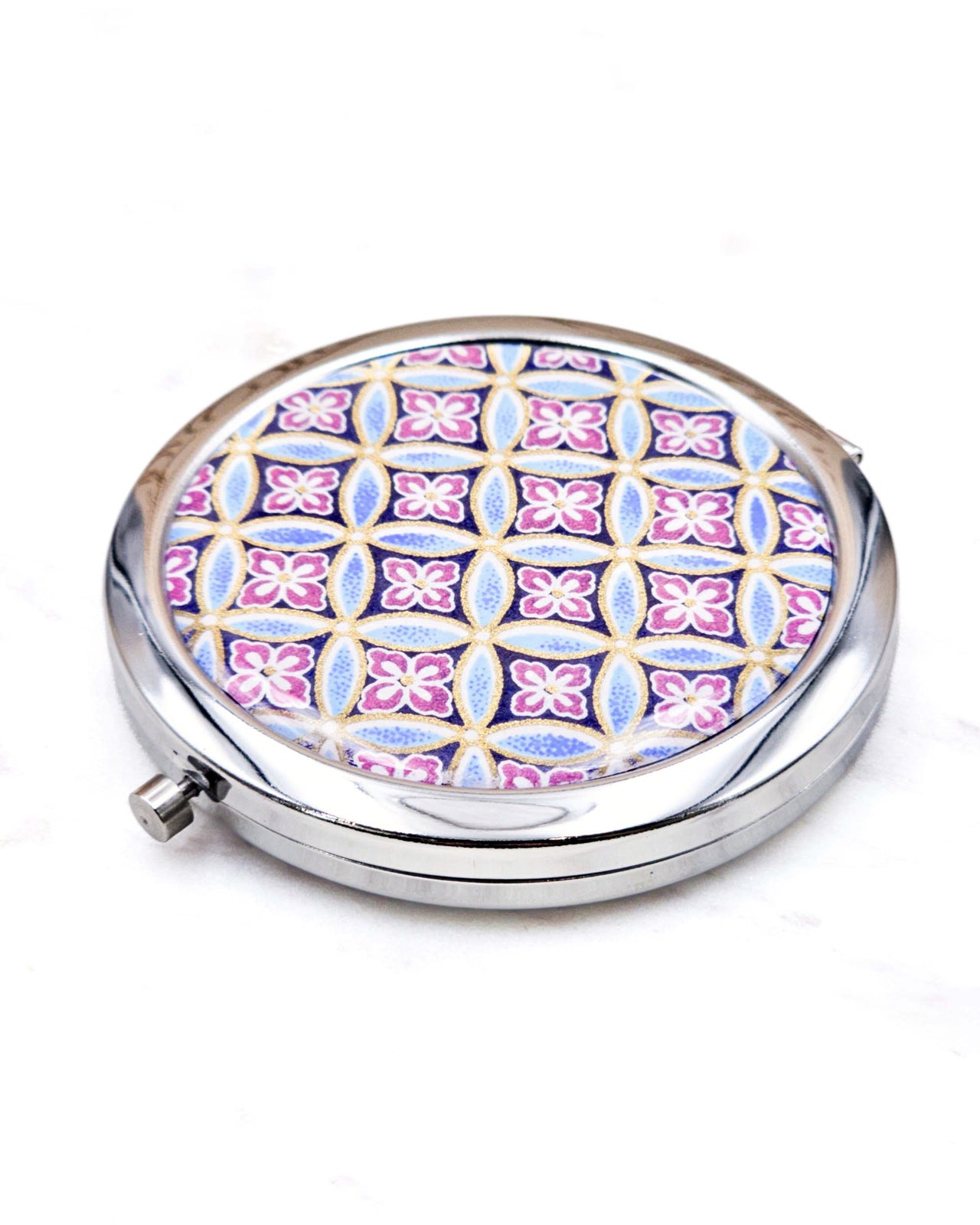 Round silver metal compact mirror featuring a traditional blue shippo pattern with purple hanabishi in the center with metallic gold accents.