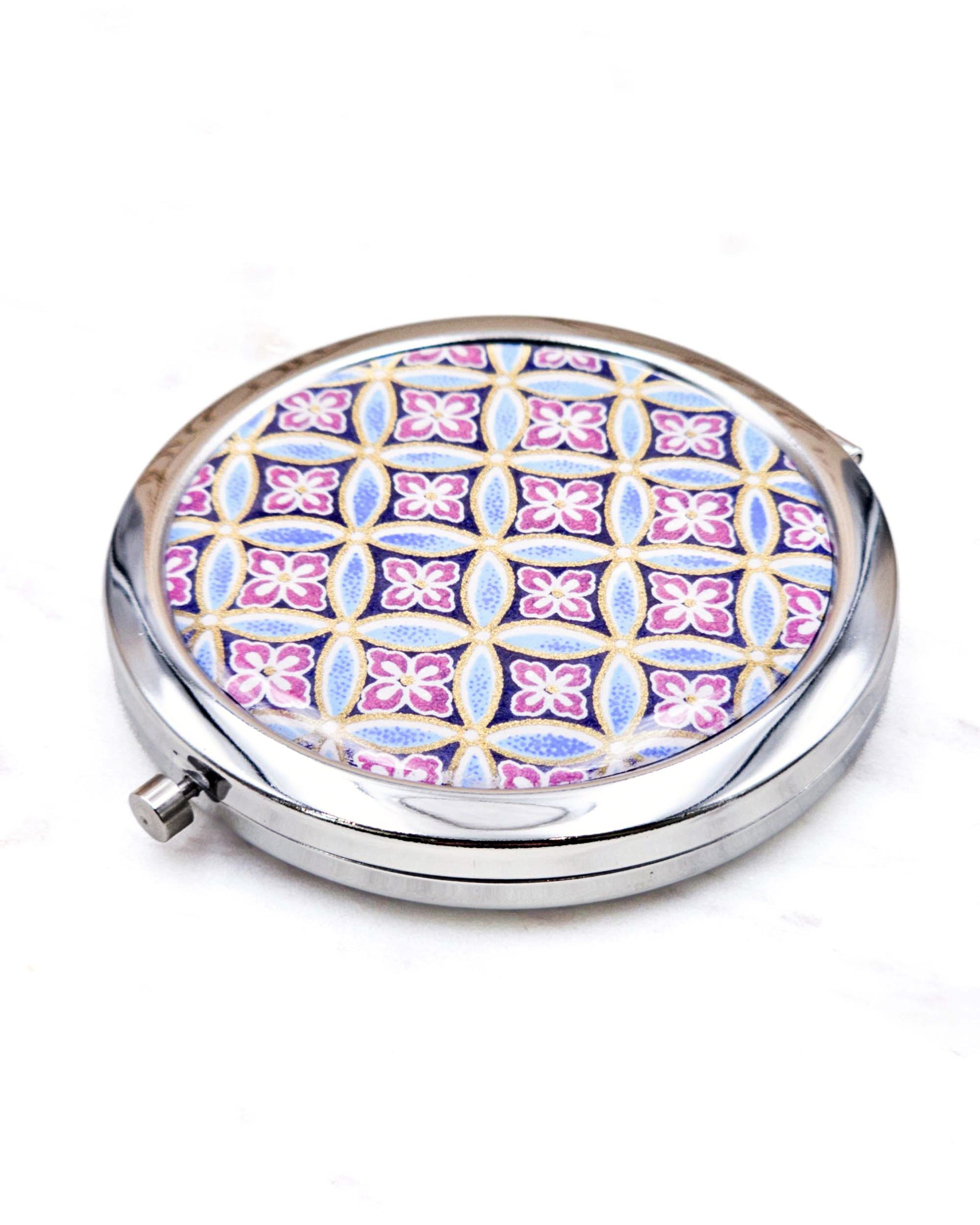 Round silver metal compact mirror featuring a traditional blue shippo pattern with purple hanabishi in the center with metallic gold accents.
