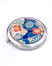 Silver metal compact mirror featuring red, white, and blue cherry blossoms with metallic gold accents.