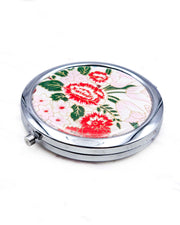 Round silver metal compact mirror featuring red and white peonies, soft pink and white flowers, and dark green leaves on a white background with metallic gold details.