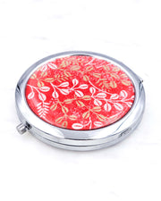 Silver metal compact mirror featuring white and metallic gold hagi blush clover on a red background.