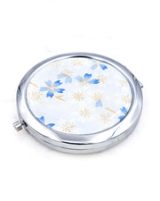Silver metal compact mirror featuring white and blue cherry blossoms on a light white and blue background with metallic gold accents.