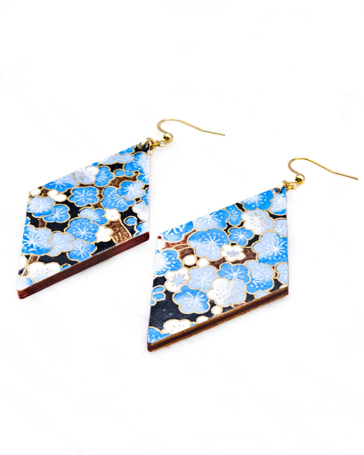 Large wooden diamond shaped earrings featuring blue plum blossom tree on a black background with metallic gold details.