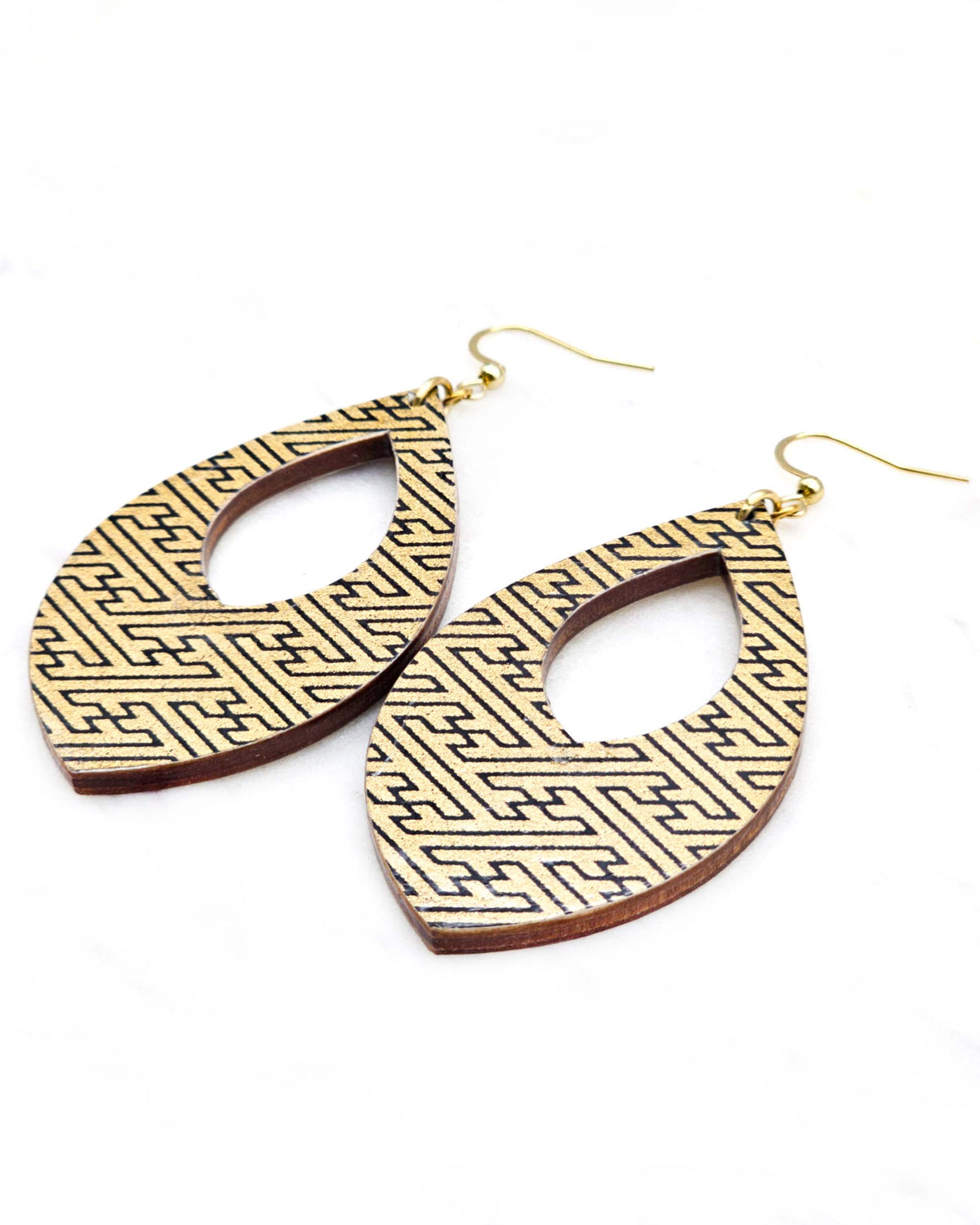 Large wooden hollow pointed teardrop shaped earrings featuring a black traditional Japanese sayagata design on a metallic gold background.