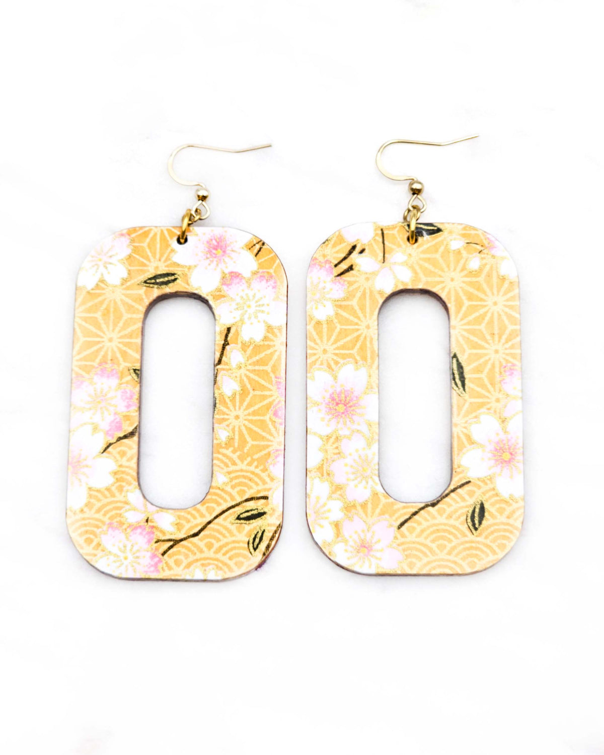 Large wooden hollow rounded rectangular earrings featuring pink cherry blossoms on an orange background with metallic gold details
