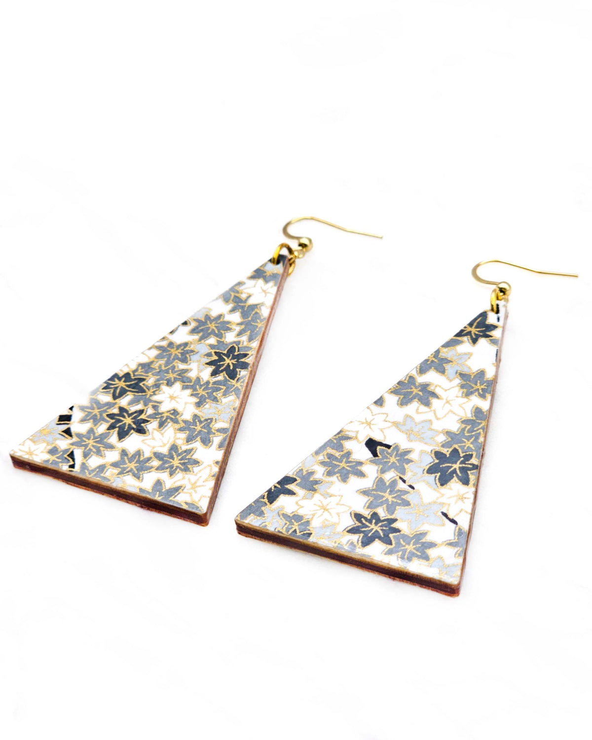 Large wooden long triangle shaped earrings featuring small gray and white momiji (maple leaves) on a light gray background with metallic gold details.