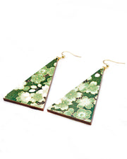 Large wooden long triangle shaped earrings featuring green and white cherry and plum blossoms with black branches on a green background with metallic gold details.